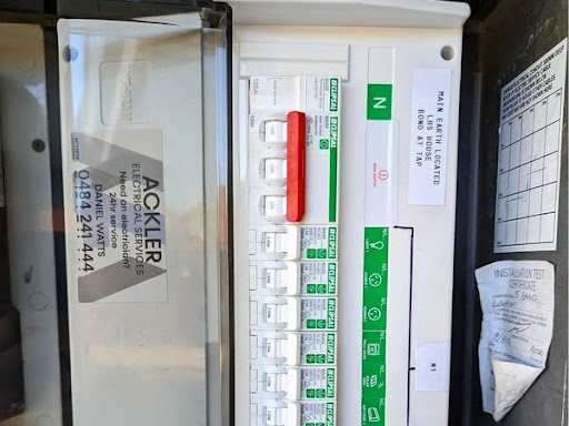 The image displays an electrical switchboard, including various circuit breakers and a residual current device (RCD). The panel is labeled with details about the installation and certification. Notably, there's a clear indication of the service provider, 'Ackler Electrical Services', signifying professionalism and compliance in electrical safety. Such panels are crucial for managing and protecting electrical circuits within residential or commercial buildings.