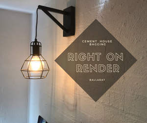 The image features a stylish wall-mounted light fixture with a black metal frame and a wire cage design, illuminating a warm light bulb. The light is attached to a simple, textured wall.