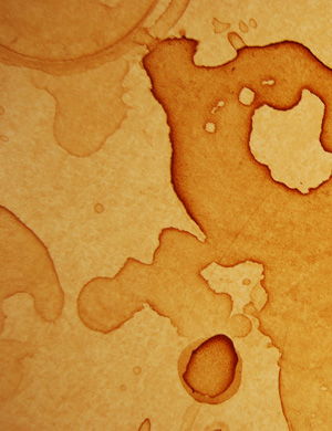 The image displays a textured background with various shades of brown, characterised by sporadic stains and patterns resembling liquid spills. This visual can represent the need for professional cleaning services, as it illustrates the aftermath of spills that might occur in commercial environments such as offices or cafés. Such marks underscore the importance of maintaining a clean workspace, which House Cleaning Cronulla can effectively address. The image serves as a reminder of the value of a thorough cleaning service to restore surfaces to their pristine condition, especially in the serviced areas of Caringbah and its surrounding locations.