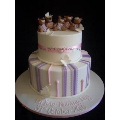 3 tier cake with scrolls and drapes topped with edible Bride & Groom figures