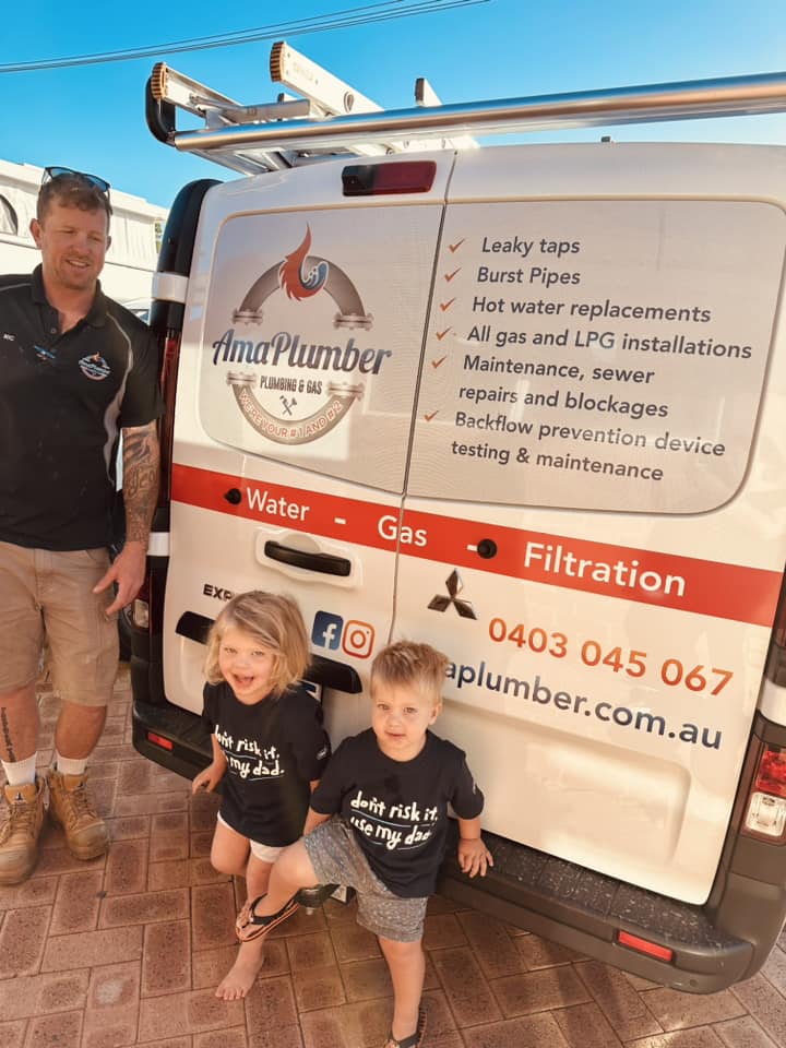 The image features a plumber standing next to a branded van for AmaPlumber Plumbing & Gas. The van displays various services offered, including leaky taps, burst pipes, hot water replacements, gas installations, sewer repairs, and backflow prevention. There are two children in matching t-shirts beside the plumber, presumably promoting a family-friendly image. The van's branding includes a clear logo and contact details, which highlights the business's focus on plumbing and gas services in the Iluka area and surrounding locations.
