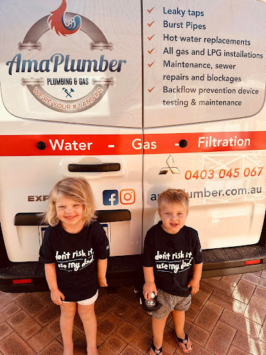 The image features two young children standing in front of a van belonging to AmaPlumber Plumbing & Gas. Both children are wearing matching black shirts with the slogan "Don't risk it, use my Dad". The van itself displays the company's logo and contact information, emphasising their plumbing and gas services, including maintenance and installation. The rear of the vehicle effectively communicates the business's focus on common plumbing issues like leaky taps and burst pipes, making it clear that they are a reliable service in Iluka and surrounding areas.